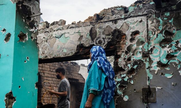 A rubble of dreams, home lost to gunfight, she waits for jailed husband